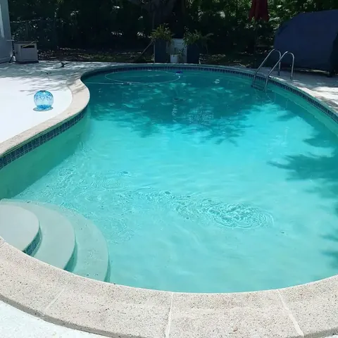 Green pool cleaned to clear water