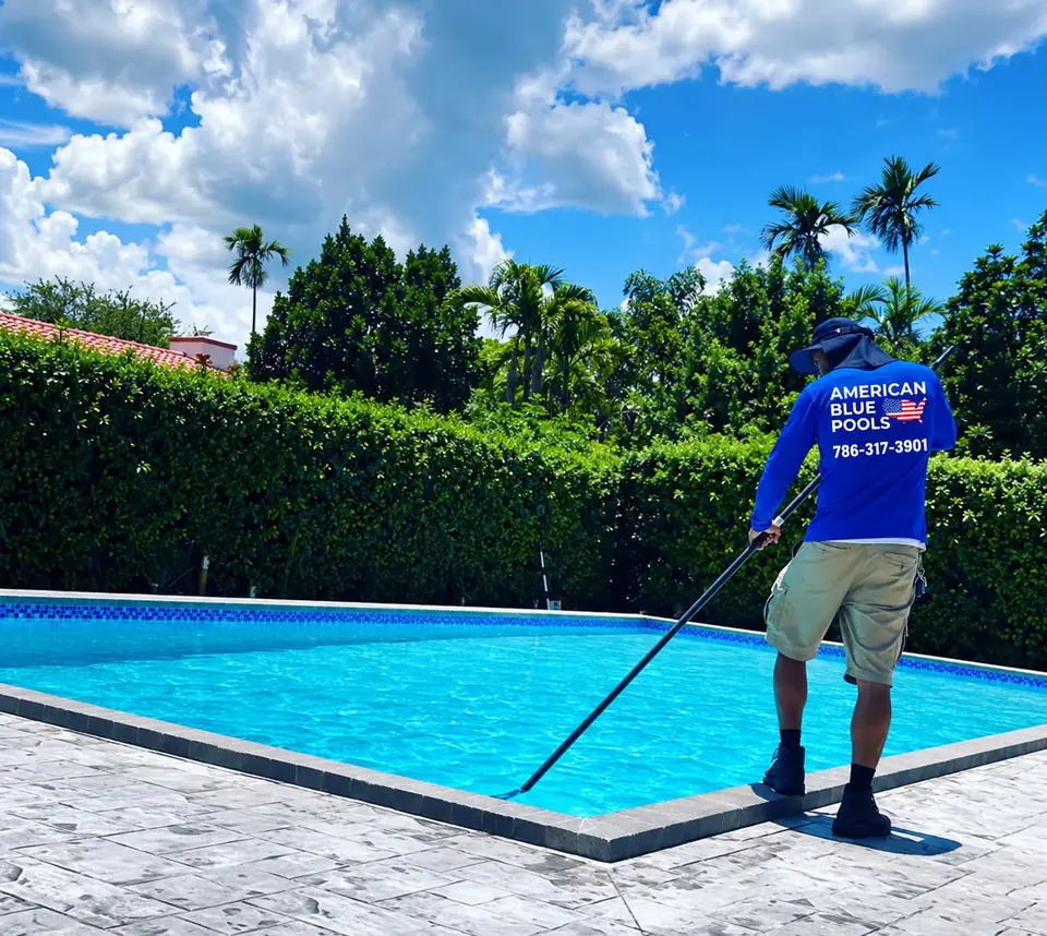 American Blue Pools technician brushing a pool