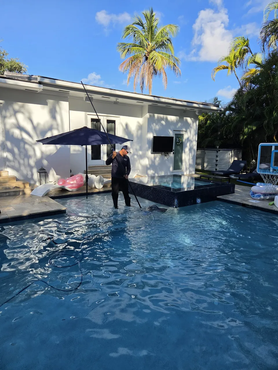 Our technician cleaning a client's pool