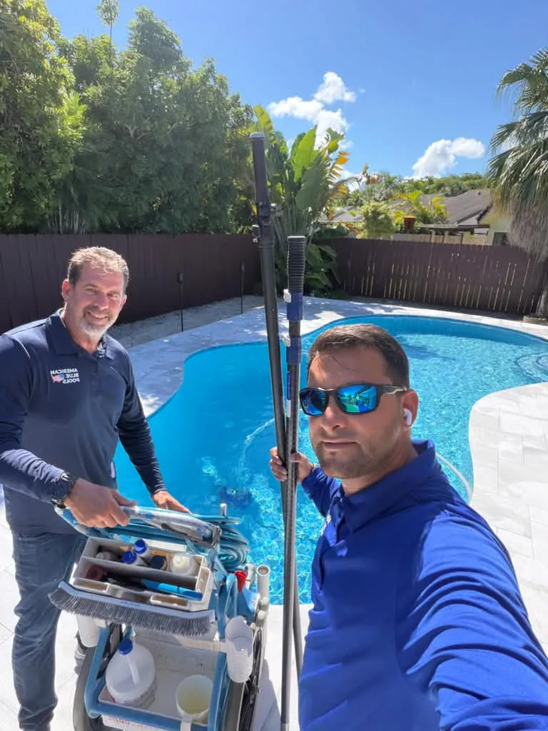 The American Blue Pools owner and a technician next to a freshly cleaned pool