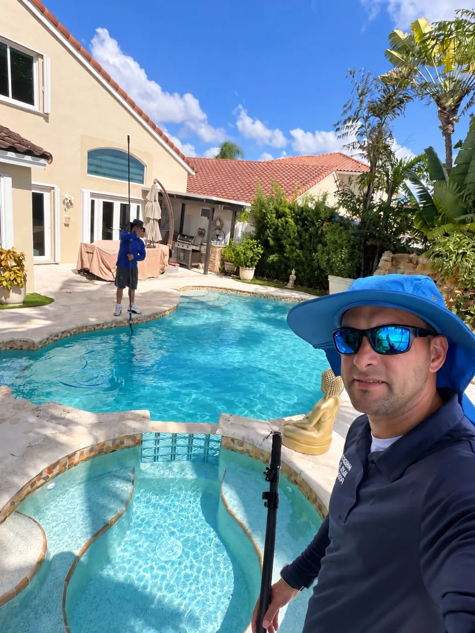 The owner of American Blue Pools servicing a client's pool and spa